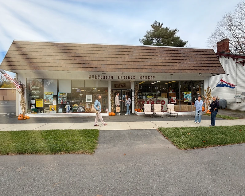 The Wurtsboro Antique Market storefront at 86 Sullivan St, decorated for autumn