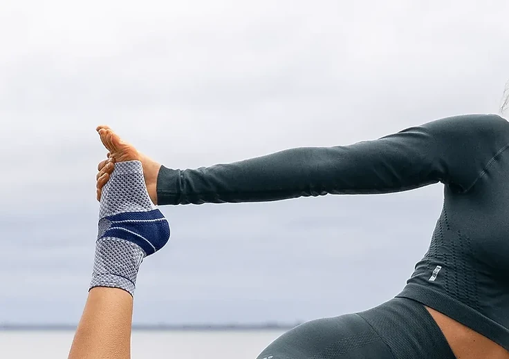 Woman in a balance pose wearing an ankle support