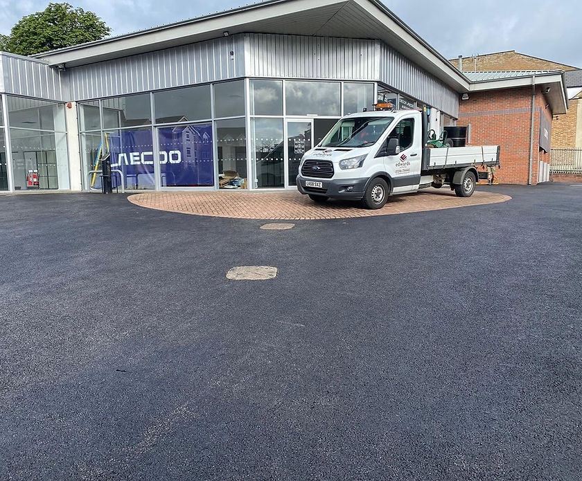 Edwards Surfacing work truck parked on a newly tarmacked commercial forecourt