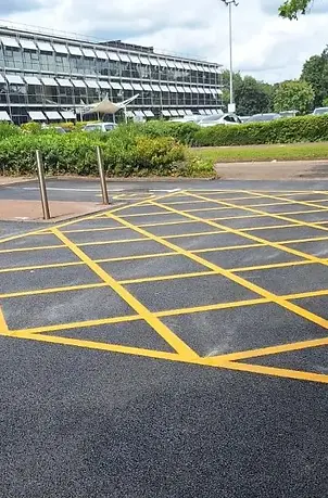 Freshly laid tarmac surfacing on a commercial site