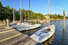 Keelboats and dinghies rigged and ready on the main pier