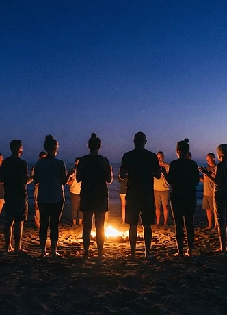 Silhouette of a diverse group standing in a circle at dusk, golden glow at the center