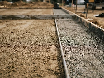 Freshly leveled earth and gravel at a finished excavation site