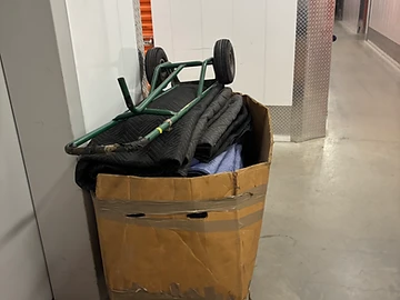 Dollies and moving pads staged at a storage facility