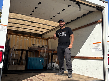 Lamas Moving mover giving a thumbs up in front of a loaded truck