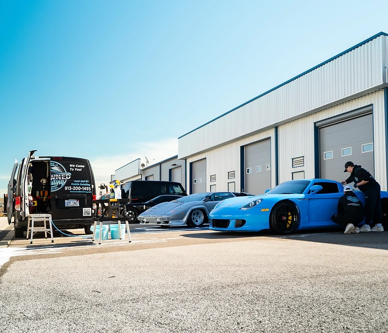The Renowned Detailing mobile team detailing a Porsche in Johnson County