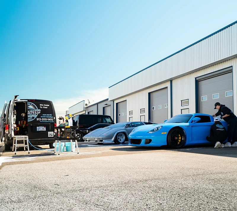 The Renowned Detailing mobile team detailing a Porsche in Johnson County
