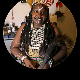 Ngatha the Seer in beaded regalia with cowrie shell necklace and ceremonial whisk