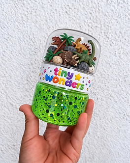 Green Dinosaur Adventure slime jar with dinosaurs, trees, eggs, and the Tiny Wonders branding strip