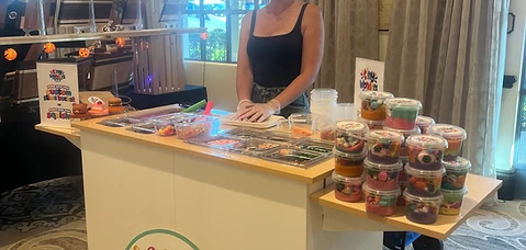 Tiny Wonders slime bar set up at an indoor event