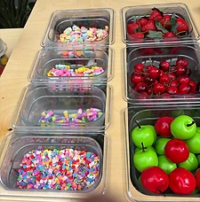 Bins of colorful slime toppings and charms