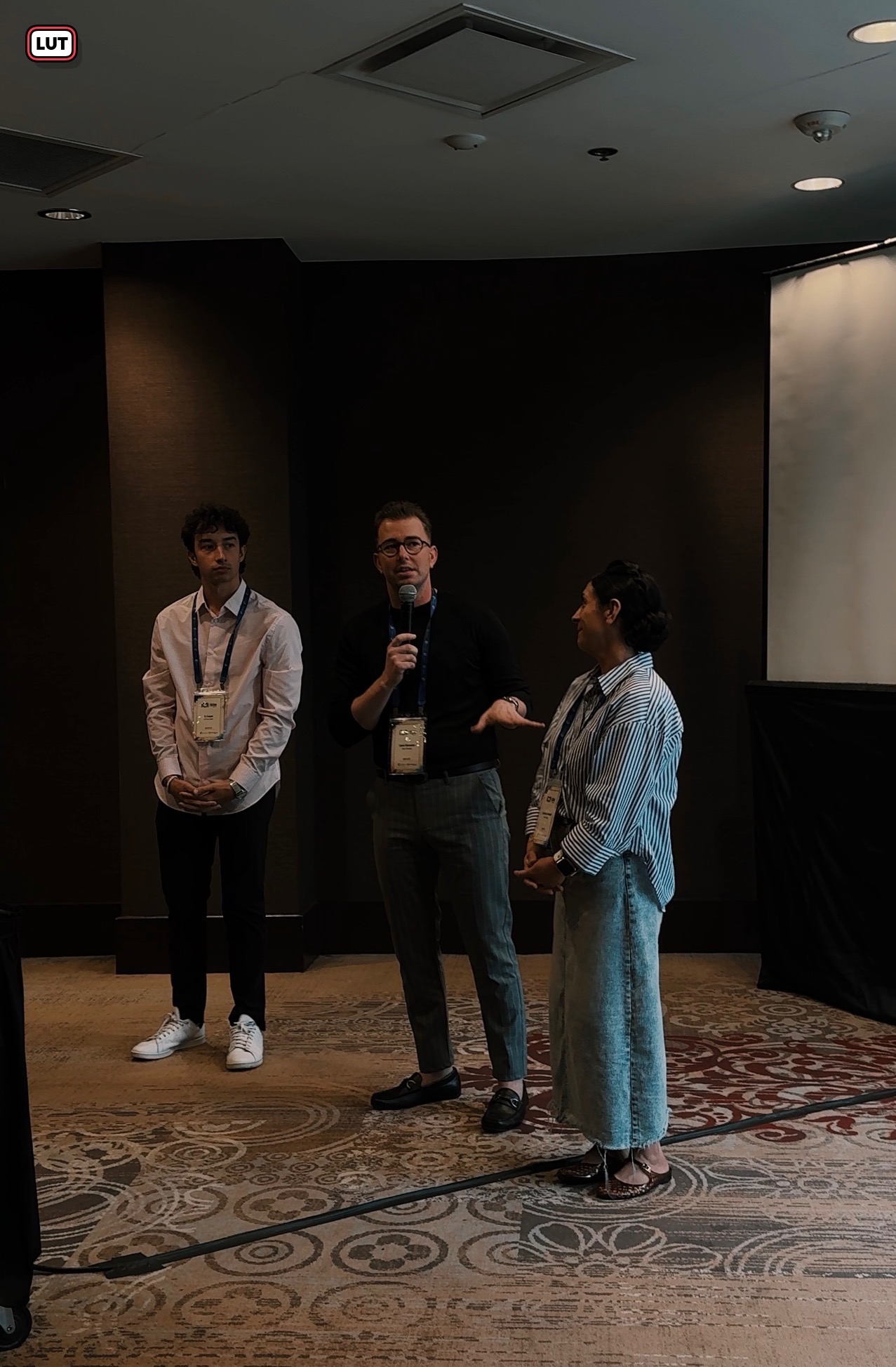 Three Elevar Financial team members speaking at an event