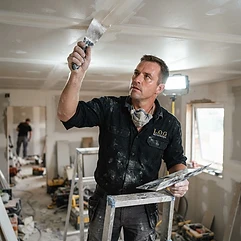 L.O.G Renovation drywall finisher applying joint compound to a ceiling seam