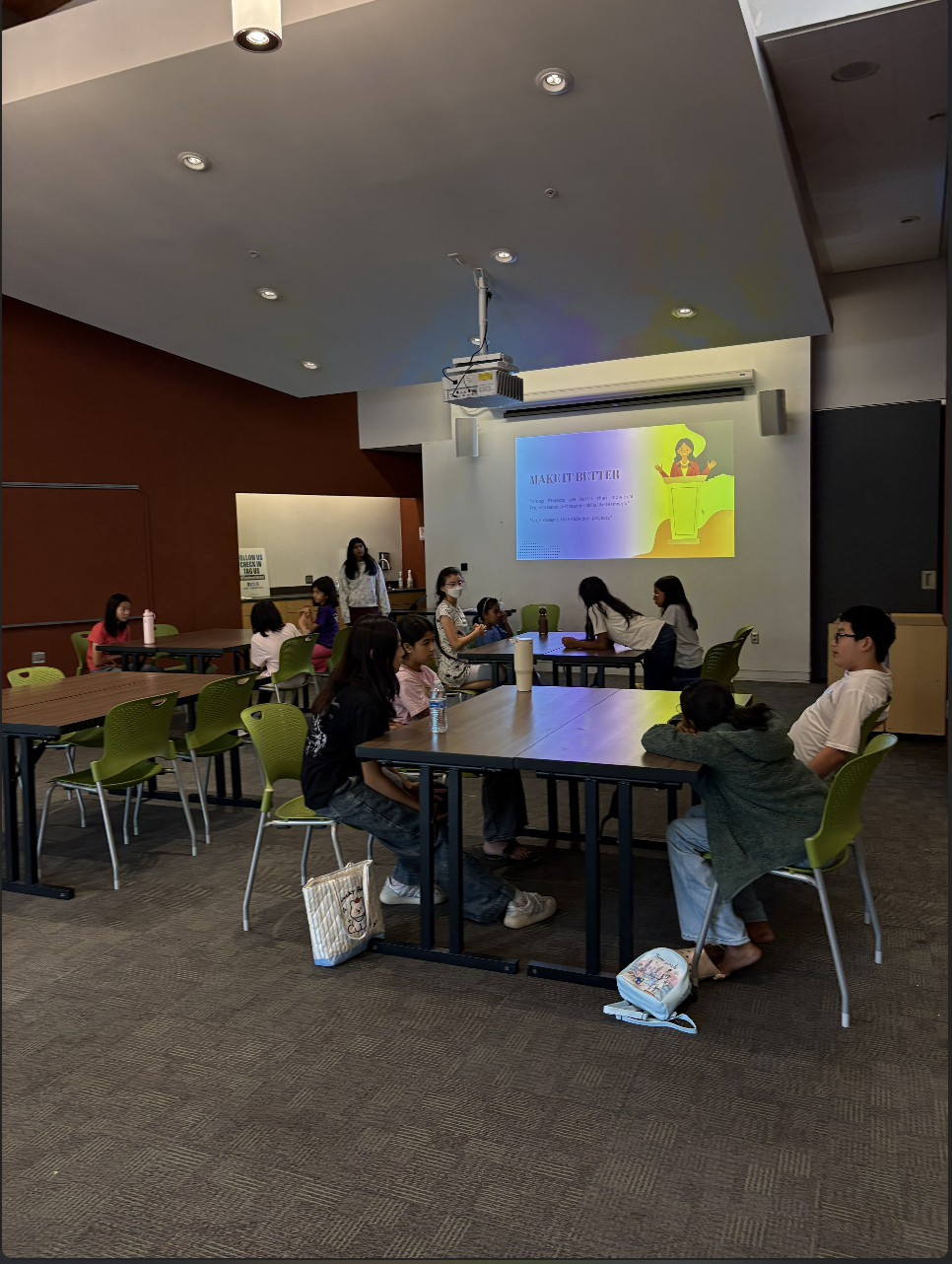 Students participating in a Take the Mic speech and debate session in a classroom.