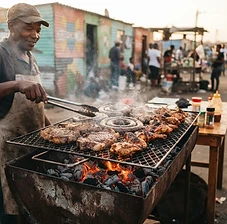 Meat grilling over charcoal at a township shisanyama
