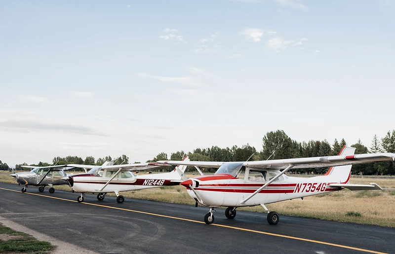 Three Apex Flight Academy training aircraft parked on the ramp in Rexburg, Idaho