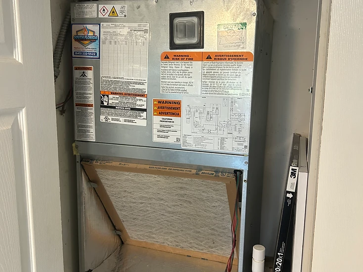 New Rheem air handler with return filter box installed in a residential HVAC closet in South Florida