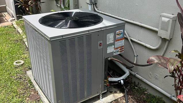 New Rheem air conditioning condenser installed outside a South Florida home