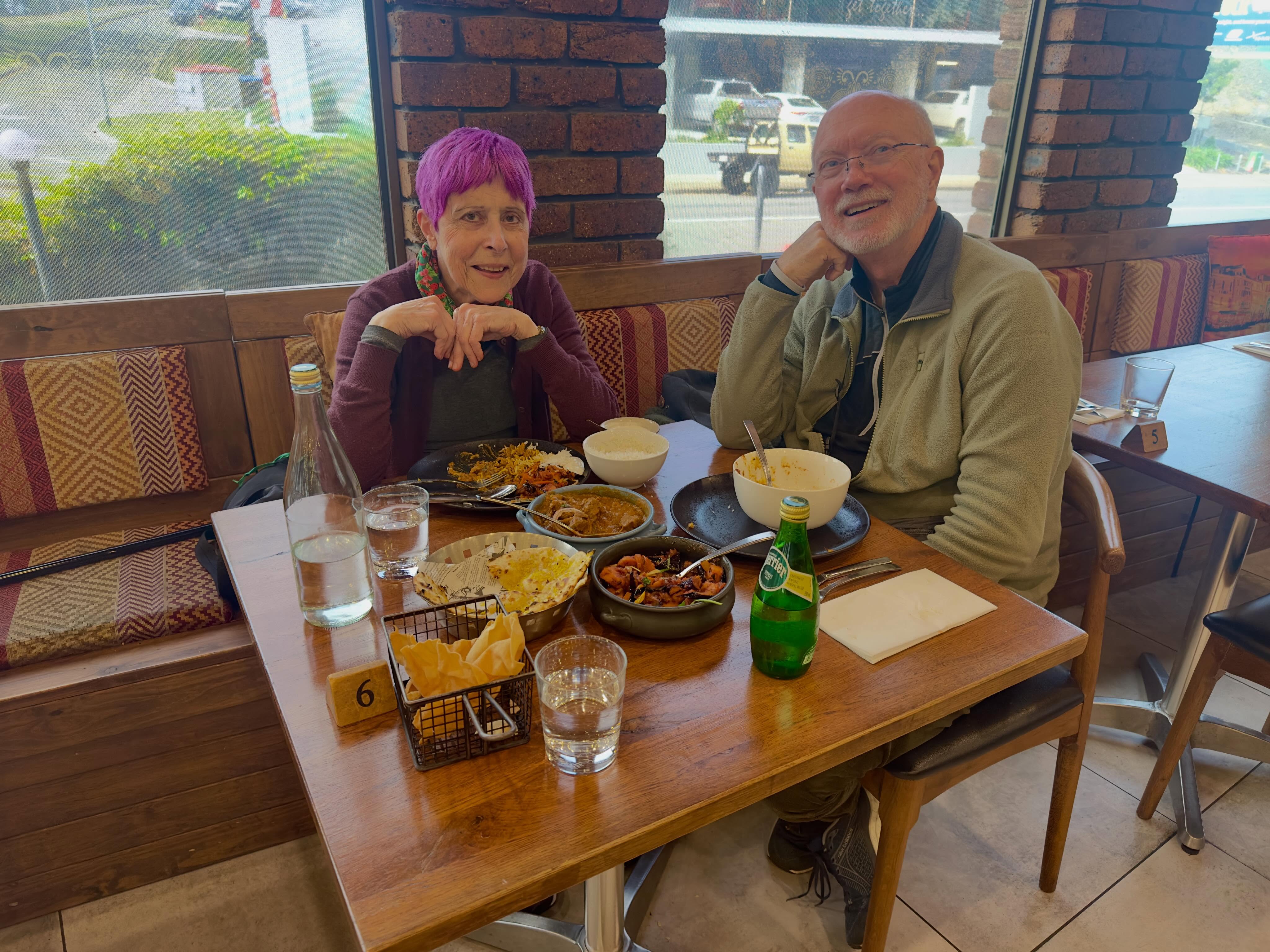 Guests enjoying a meal together in a booth