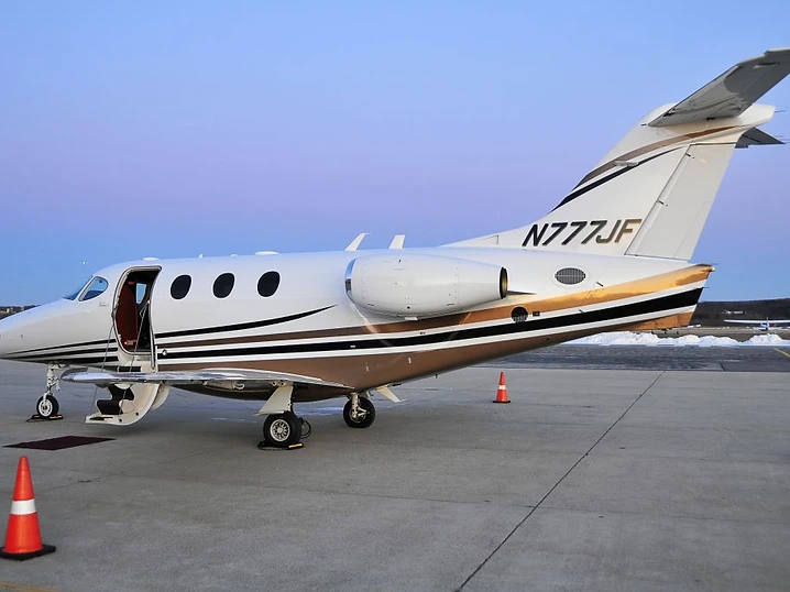 Business jet being detailed inside a hangar