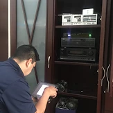 Technician configuring home A/V equipment