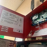 Open fire alarm control panel with cellular communicators