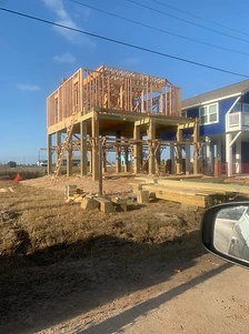 Elevated beach home framing under construction on stilts