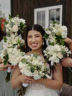 Bride surrounded by white bouquets