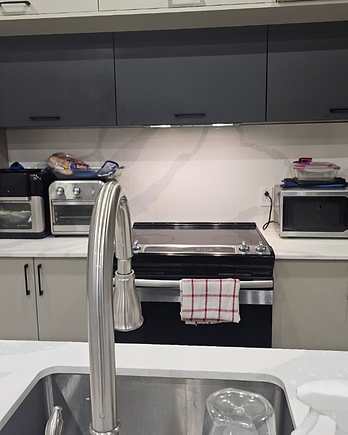 Kitchen countertop and appliances staged for guest arrival