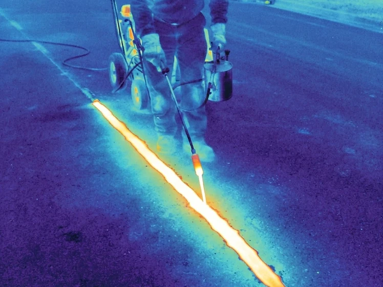 Thermal infrared view of hot pour sealant at 400°F filling an asphalt crack