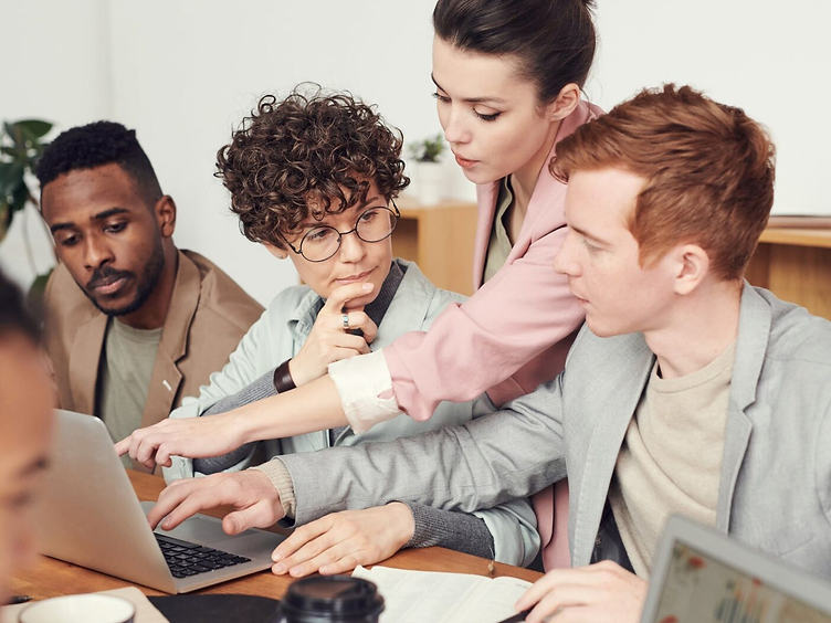 Copybox team collaborating around a desk