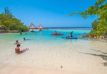 Beach scene with kayaks and overwater tiki huts