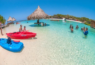 Guests swimming and kayaking in the turquoise lagoon