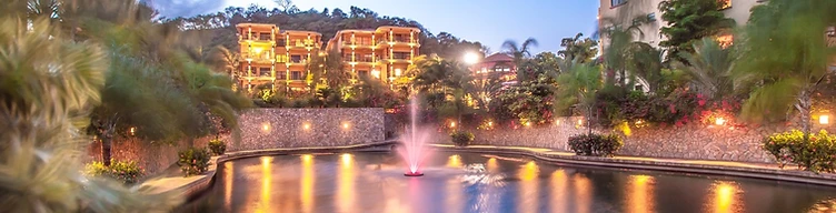 Reflecting pond with fountain at twilight
