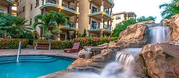 Pool with cascading waterfall and bougainvillea