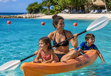 Family kayaking in the turquoise lagoon