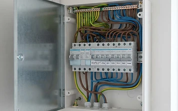Open electrical consumer unit being inspected during an EICR