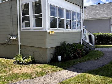 Small landscaped bed with fresh mulch against a home