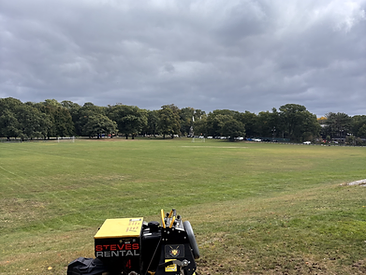 Commercial mower on a large mowed field