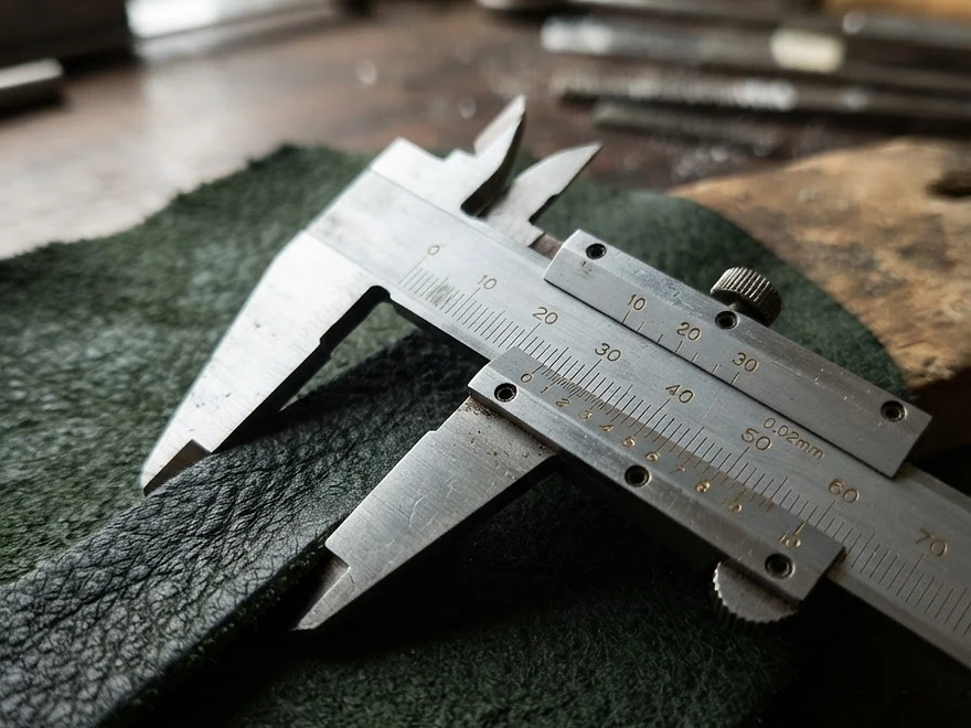 Caliper measuring a leather sample