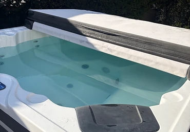 Folded-back cover on a white shell spa