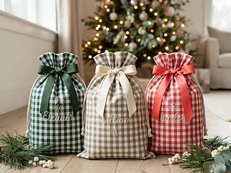 Green, khaki and red gingham Christmas gift sacks styled with pine and berries