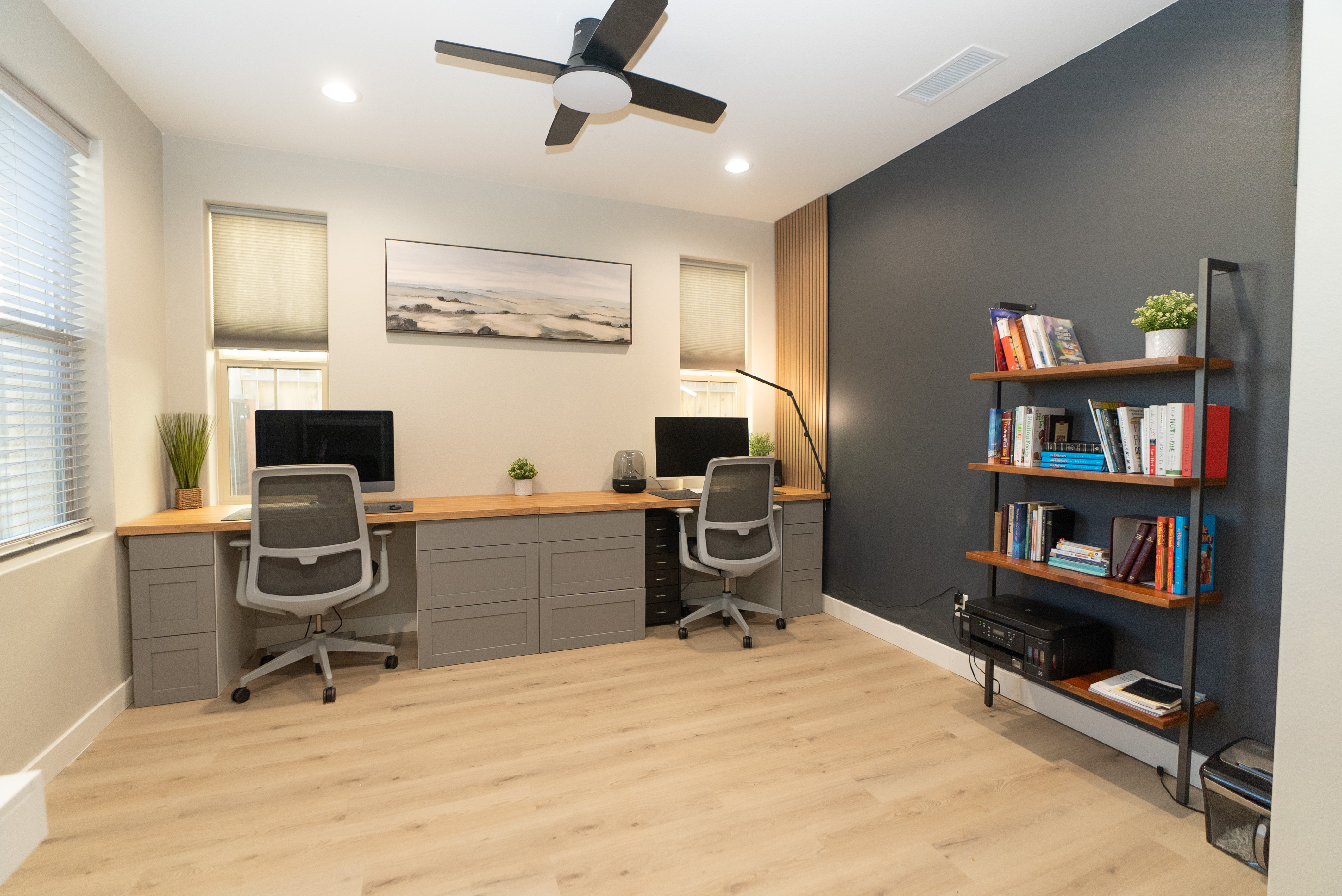 Modern home office with charcoal accent wall and oak desk