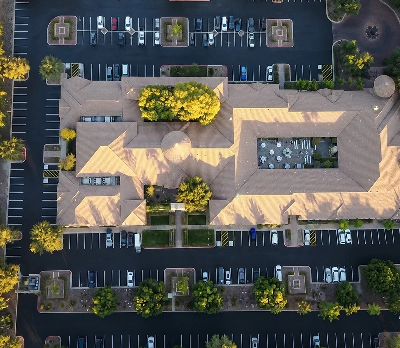 Aerial drone view of a commercial asphalt parking lot