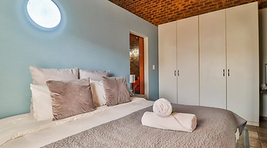 D Block bedroom with quality linen at Rudman Townhouses