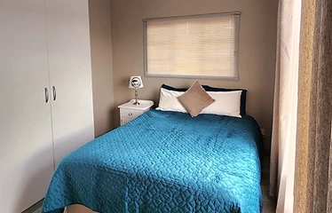 Double bedroom with quality bedding at Rudman Townhouses