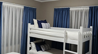 Second bedroom with bunk beds in the two-bedroom unit at Rudman Townhouses