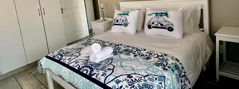 Main bedroom with double bed in the two-bedroom unit at Rudman Townhouses