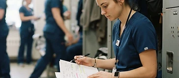 Student nurse reviewing notes before clinical shift.