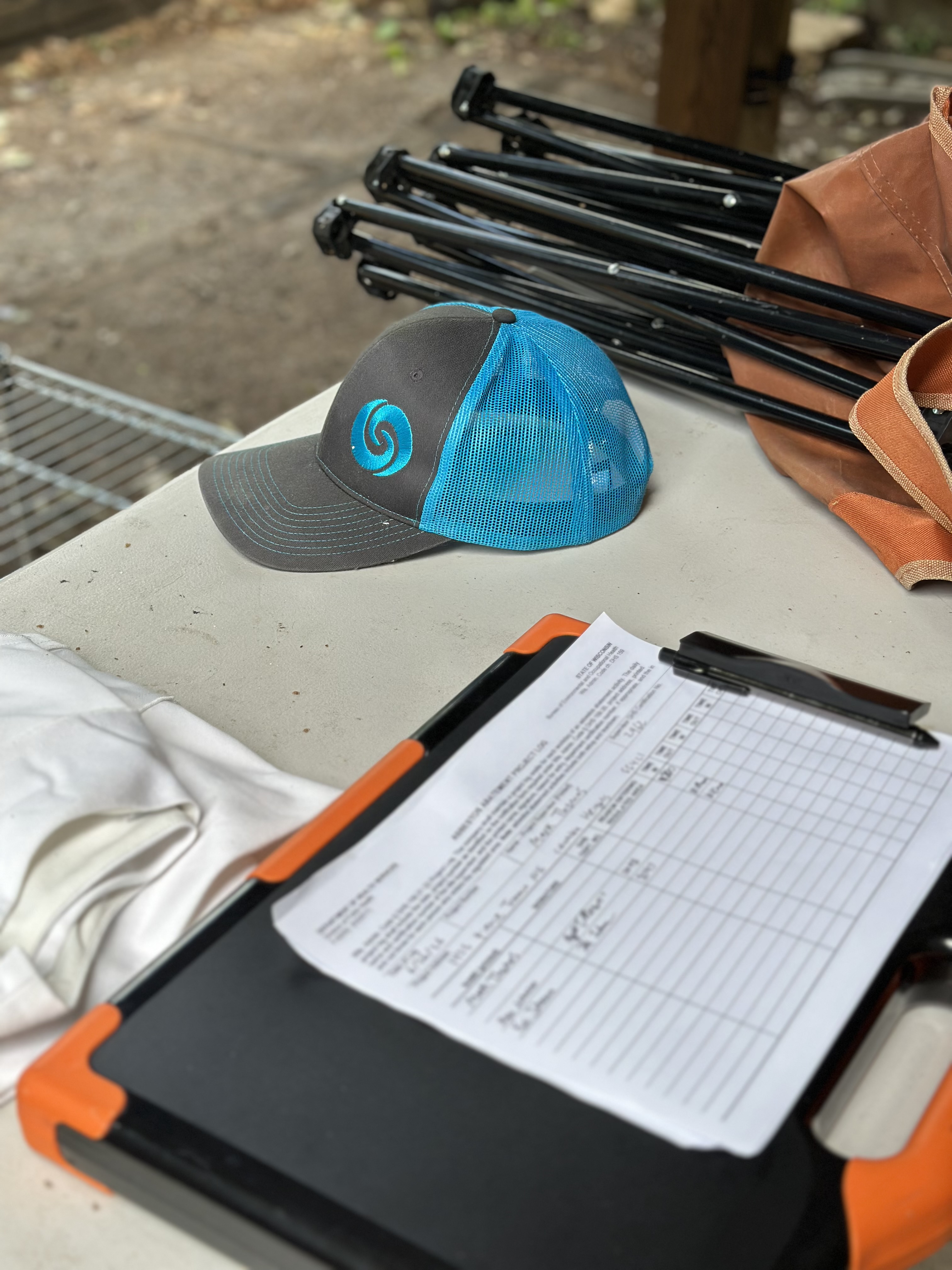 Asbestos abatement project log clipboard and branded crew cap